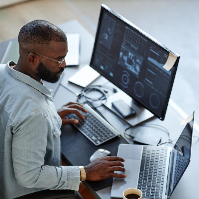 An IT expert working on his computer and performing IT maintenance and updates.