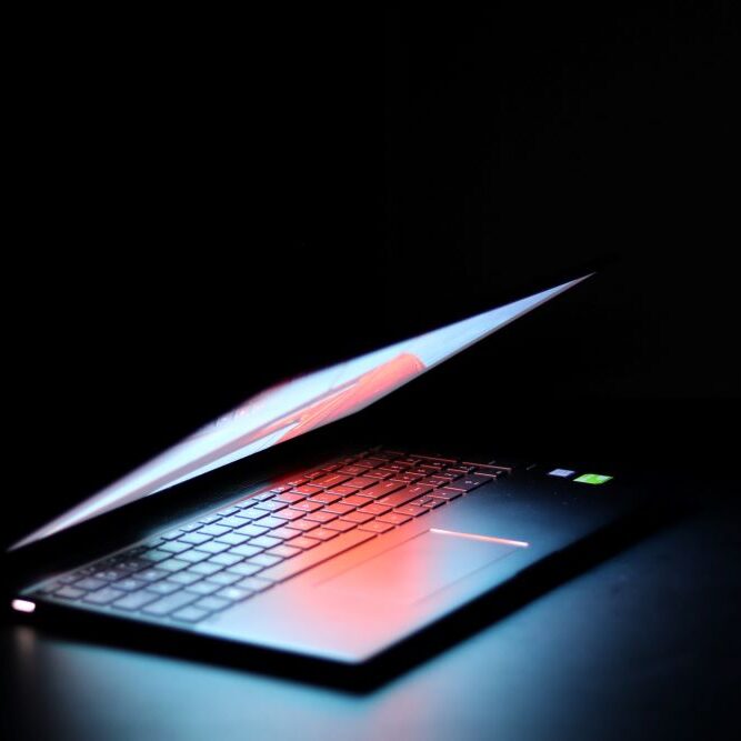 A Lenovo computer with a bright display on a dark background.